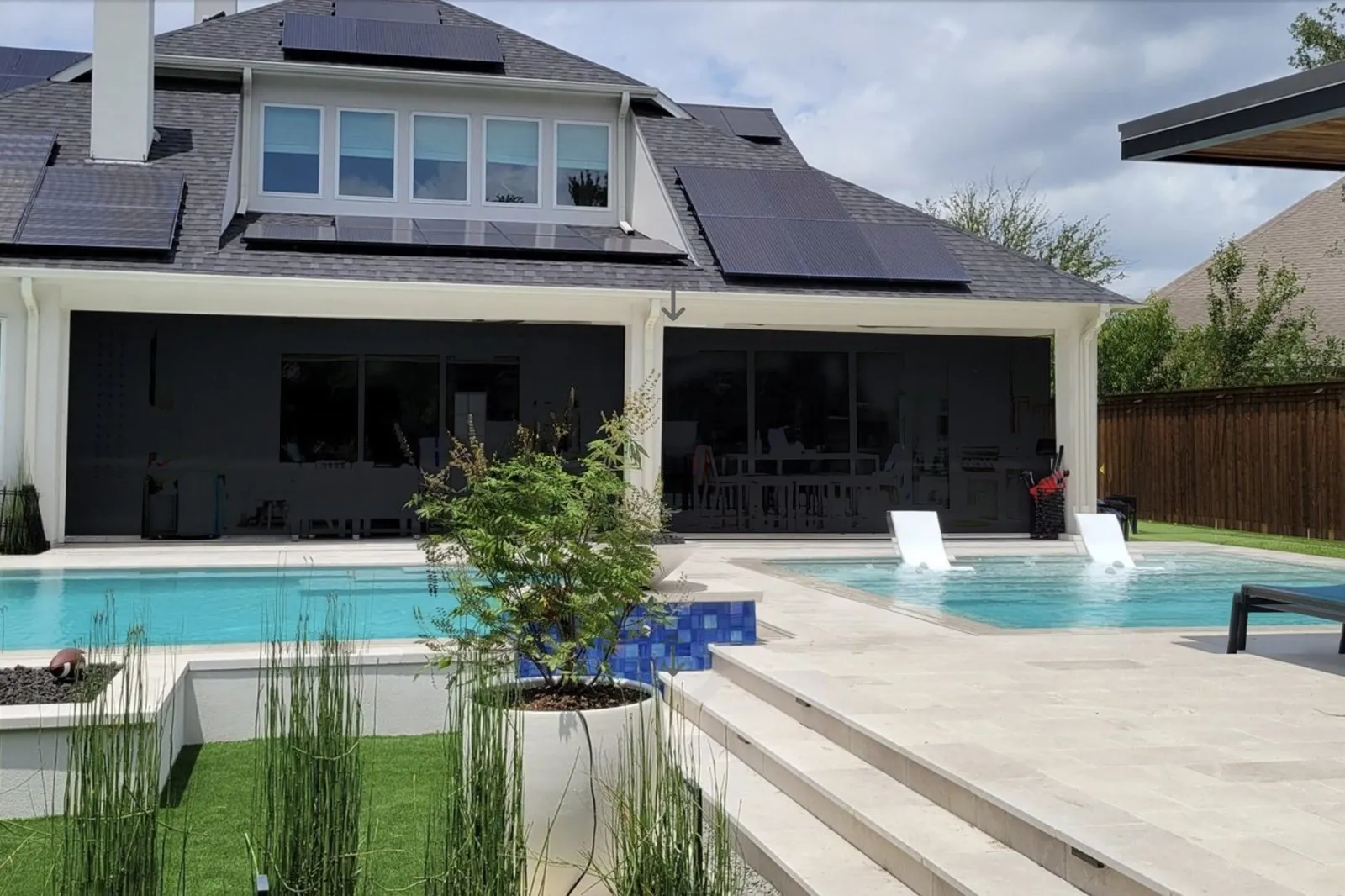 The same patio with motorized screens fully lowered